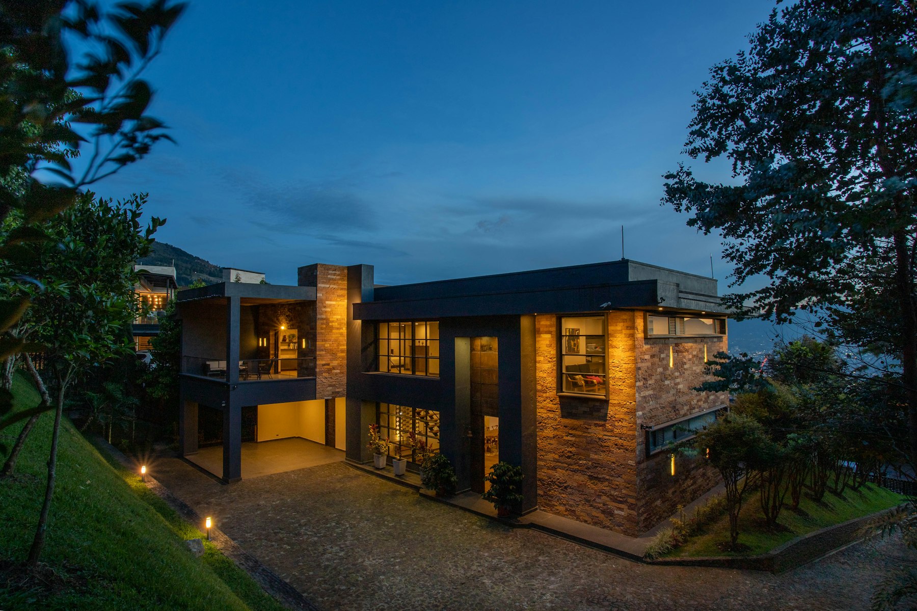 A modern villa at night, its lighting engineered by KLOQ